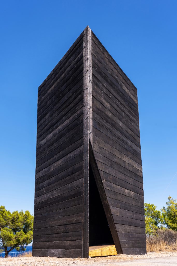 Arriving at the boat-shaped charred-timber pavilion