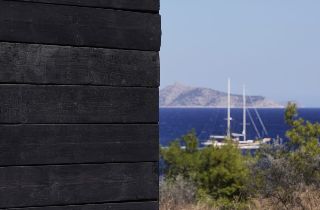 Charred external cladding with a boat beyond
