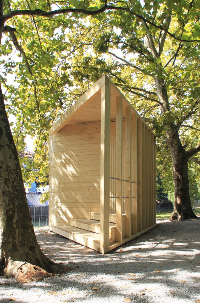 The pavilion reaching through the tree-line towards the path